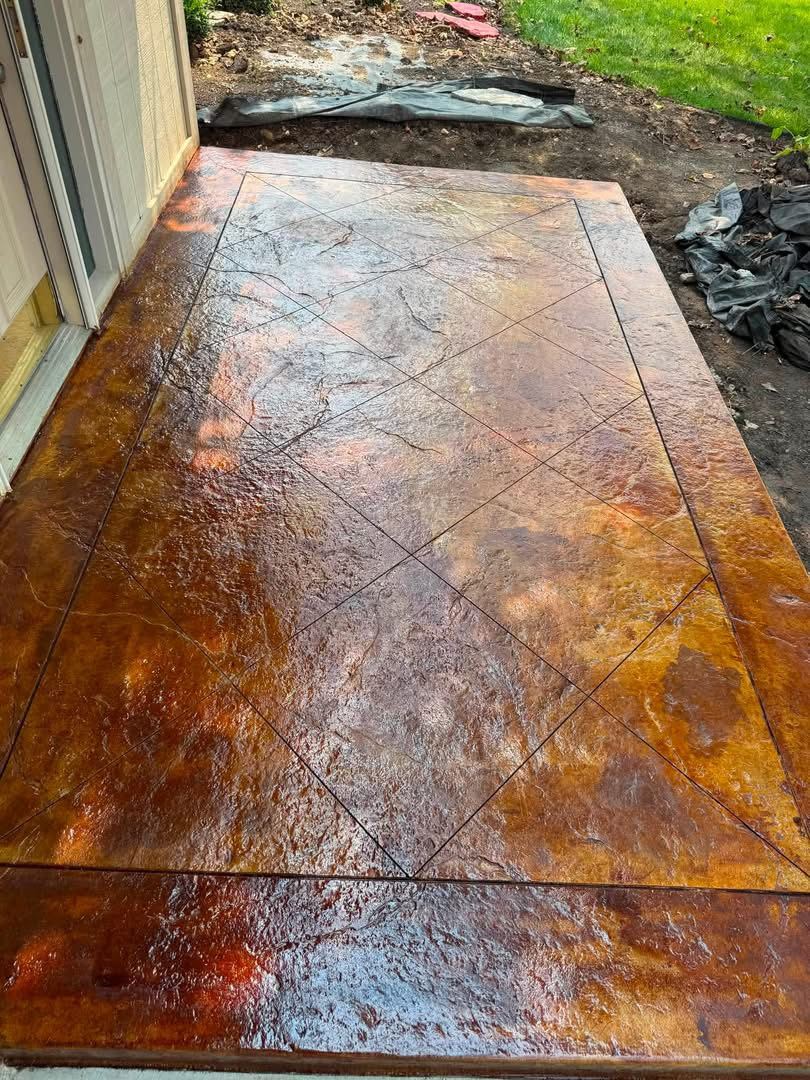Acid-stained back patio. Diamond-scored slab with a rich amber stain.