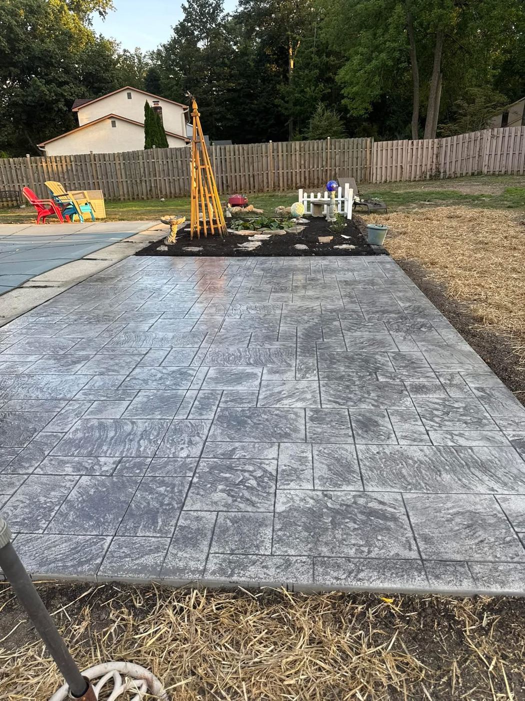 Stamped patio by the pool. Ashlar-slate pattern with gray release color.
