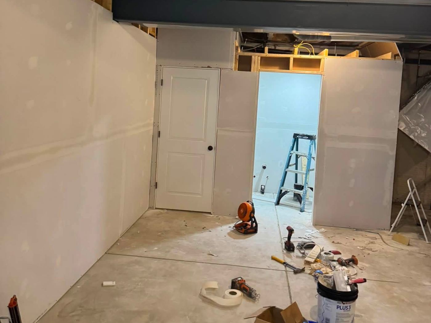 Unfinished basement with bare drywall