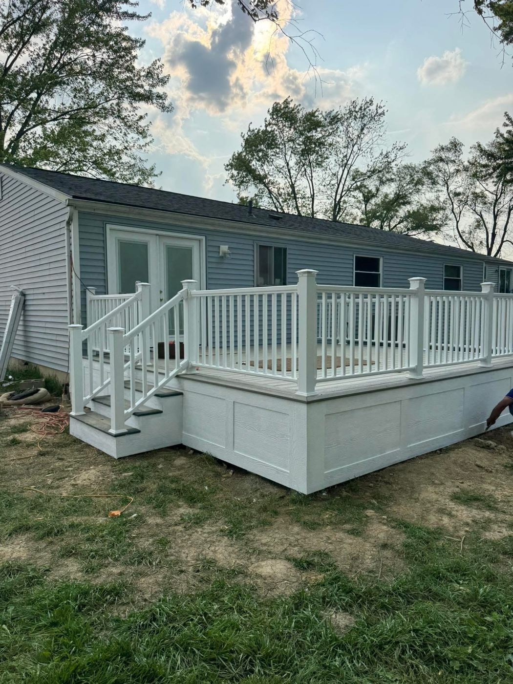 Composite deck. Low-maintenance decking, white rails and skirting.