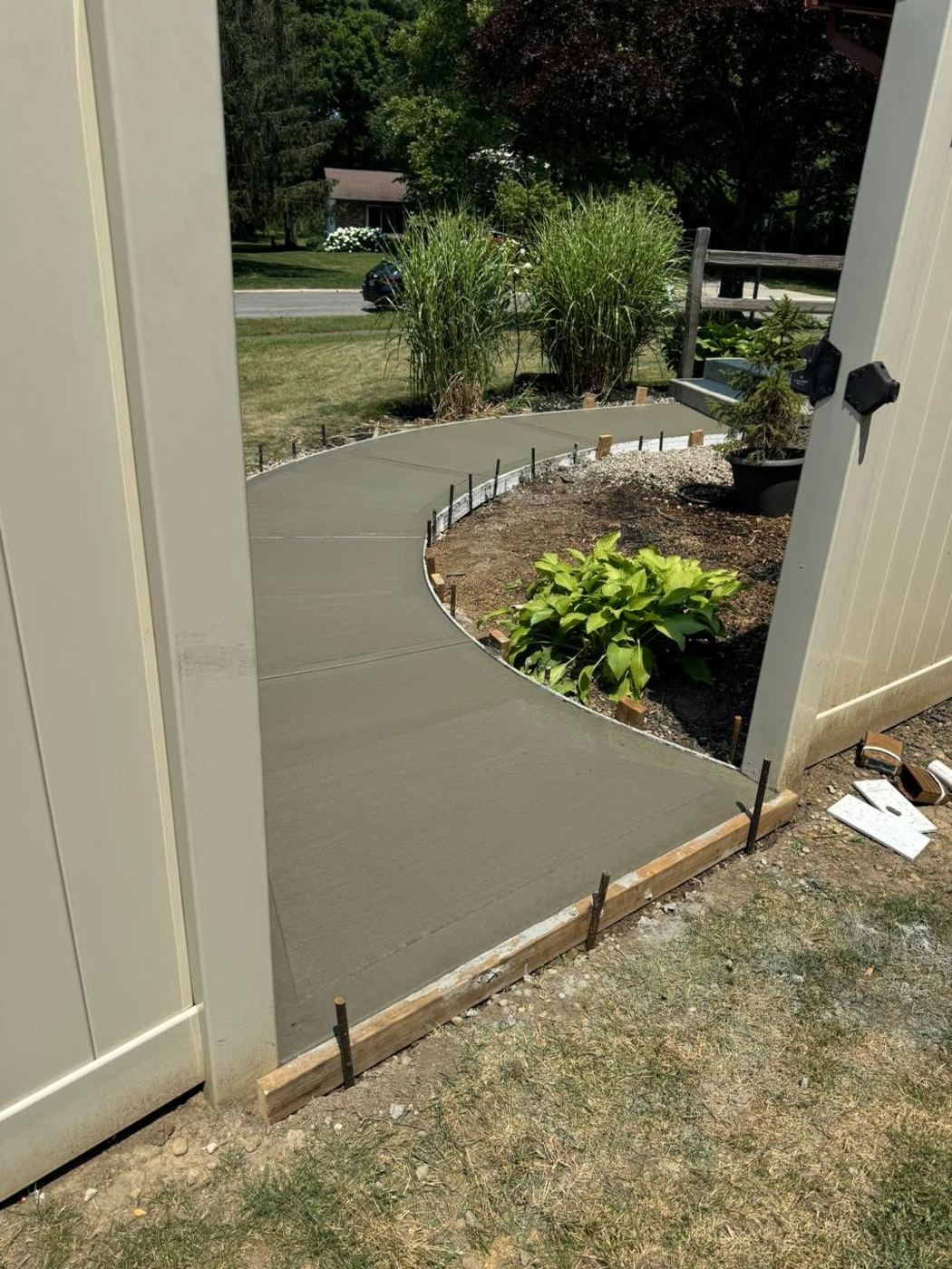 Curved walkway. Sidewalk curving through the garden bed.