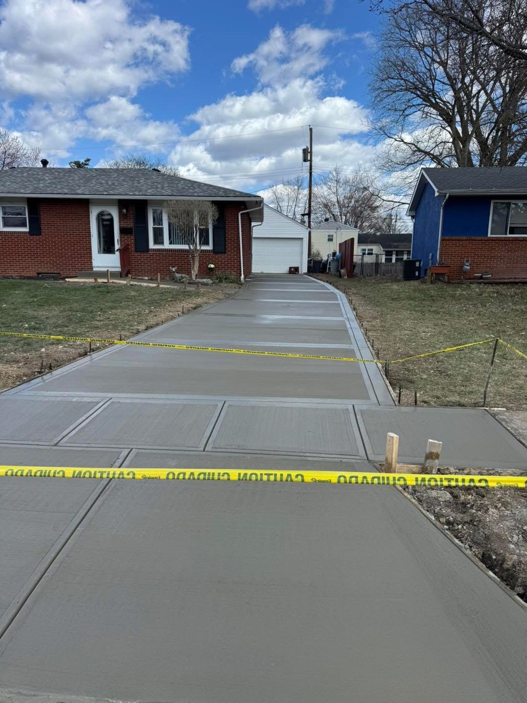 Driveway, apron and sidewalk. Tooled borders and control joints throughout.