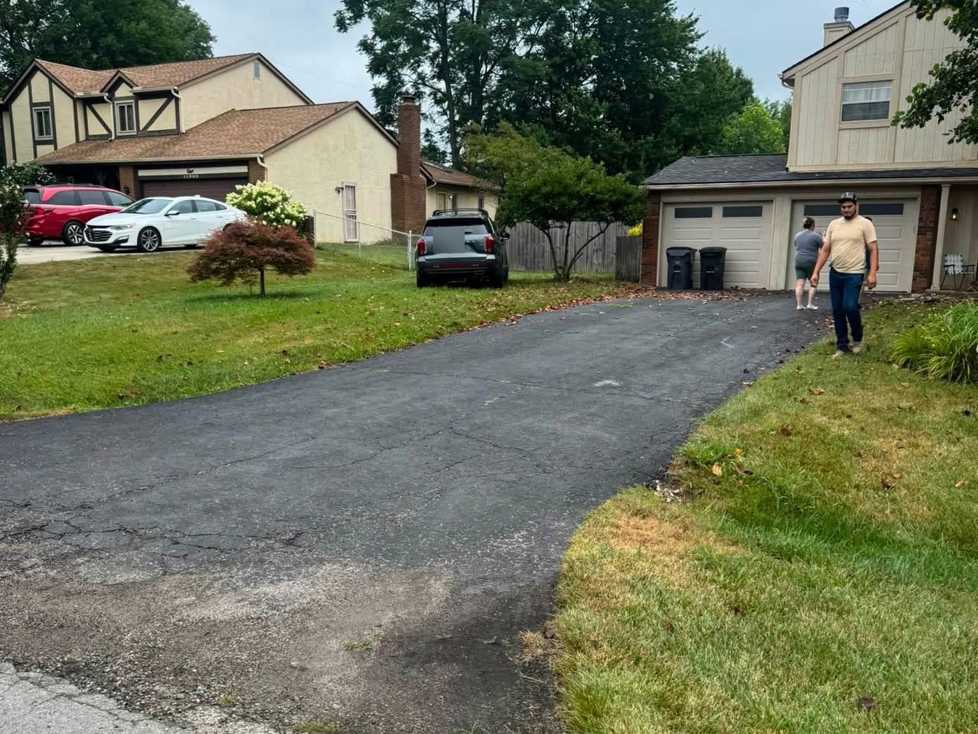 Old asphalt driveway, cracked and patched