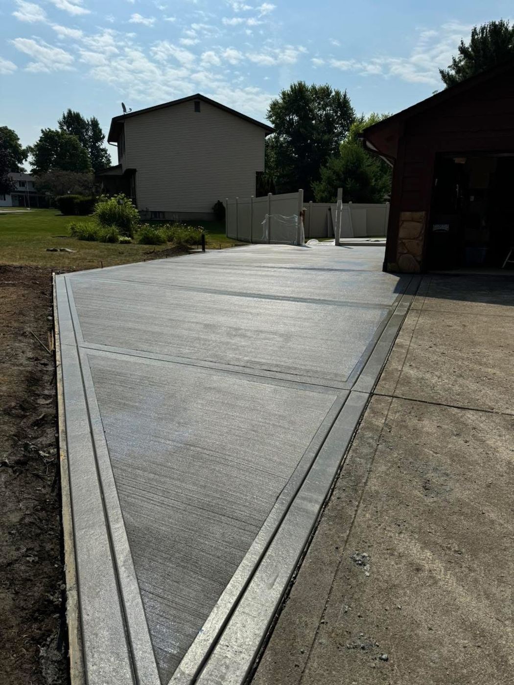 Driveway extension. Widened driveway with tooled borders.