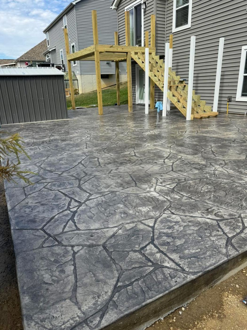 Patio under a new deck. Flagstone stamp in charcoal.