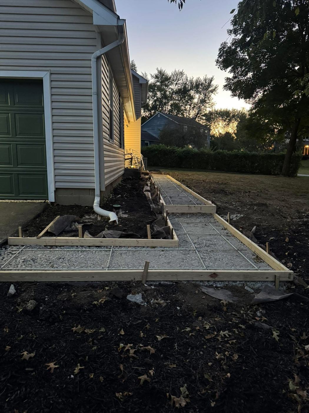 Forms, base and wire mesh. Prep before the pour: compacted stone and reinforcement.