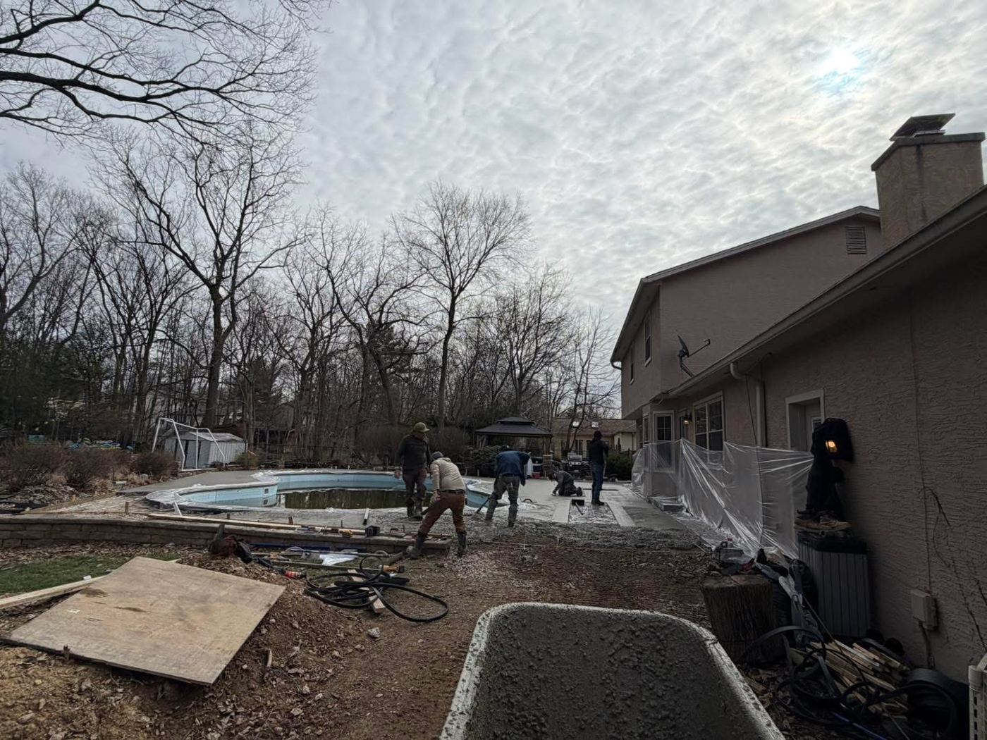 Crew placing stone base around the pool before the pour