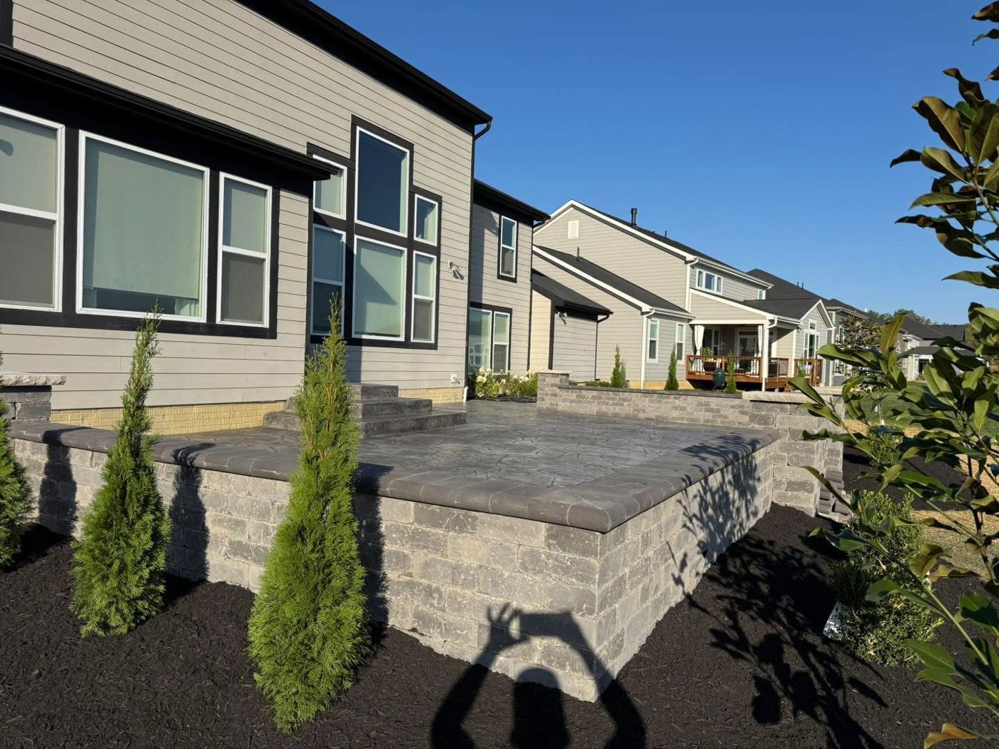 Raised patio with block wall. Stamped patio, seat wall, steps and new plantings.