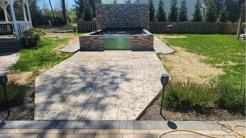 Patio and stone water wall. Stamped patio built around a stone water feature.